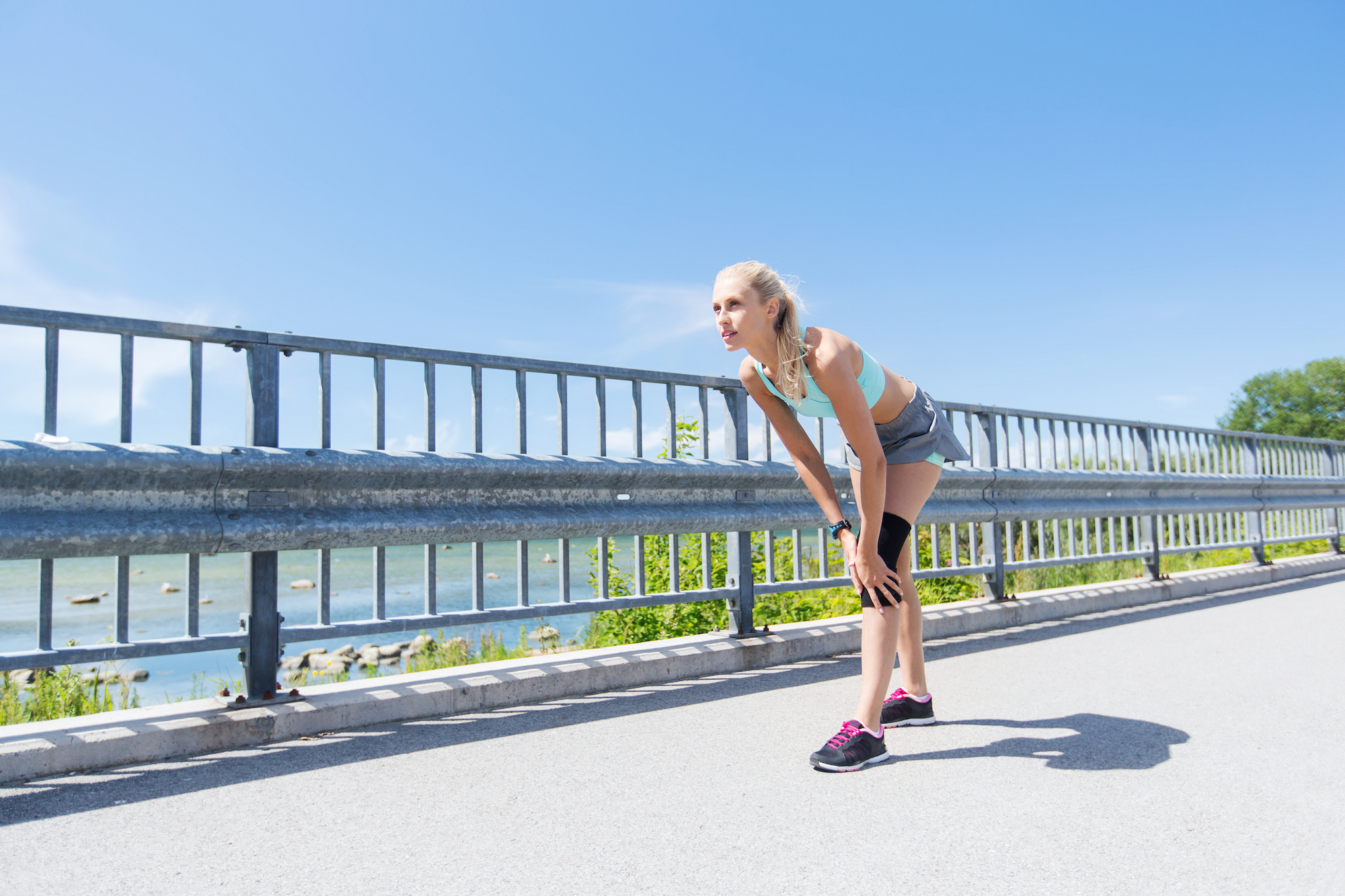 woman holding knee during exercise