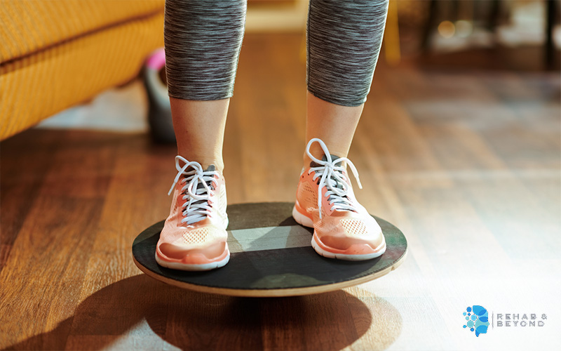 A person standing on a balance board during exercise