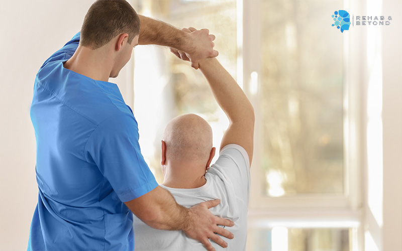 Physiotherapist rehabilitating mobility in patient